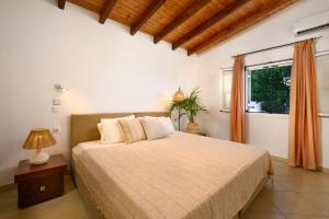 a bedroom with a large bed and a window at Aether Messonghi - Seaview Collection Corfu in Mesongi