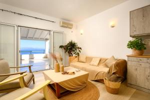 a living room with a couch and a table at Aether Messonghi - Seaview Collection Corfu in Mesongi