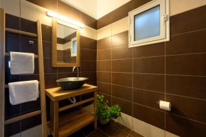 a bathroom with a sink and a mirror at Aether Messonghi - Seaview Collection Corfu in Mesongi +16 photos