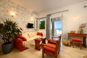 a living room with a couch and a table at Aether Messonghi - Seaview Collection Corfu in Mesongi