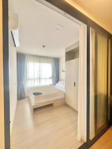 a bedroom with a bed and a large window at Dcondo reef 99 in Kathu +21 photos