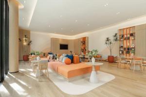 a living room with a couch and tables and chairs at Dcondo reef 99 in Kathu
