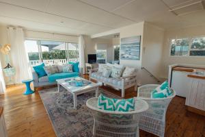 a living room with a couch and a table at Seabreeze in Hermanus
