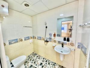 a bathroom with a sink and a toilet at Văn Phượng Hostel in Cat Ba +12 photos