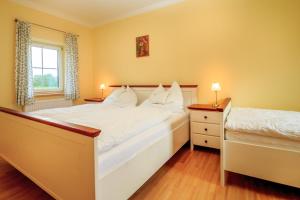 a bedroom with a large white bed and a window at Wittinghof in Julbach +41 photos