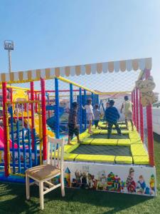 a group of children playing on a playground at Porto Sharm Family Chalet with Pool View in Sharm El Sheikh