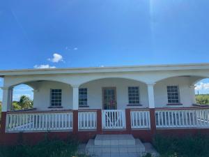 a large white house with a large porch at Jared's Place in The Quarter