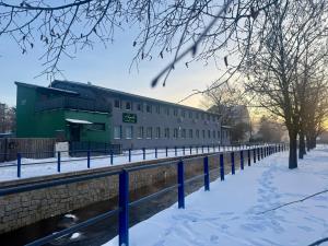 a building next to a river in the snow at ANPELA in Rýmařov
