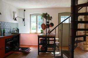 a kitchen with a spiral staircase in a room at Idyllic Hideaway In The Countryside in Marienwerder