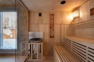 a sauna with wooden walls and a glass door at Apartamenty Krupówki 20 in Zakopane