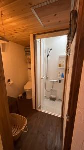 a bathroom with a shower and a toilet at Guest House時音 in Joetsu +23 photos