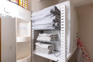 a stack of towels in a closet at Bushido Kashiwa in Kashiwa +68 photos