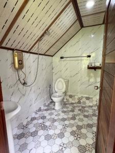 a bathroom with a toilet and a sink at Bangalow Coconut corner in Ban Laem Sai
