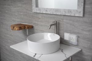 a white sink on a counter in a bathroom at Calma Eco Hotel in Thoddoo +73 photos