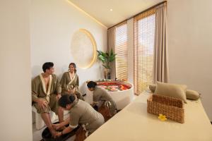 a group of people standing in a room with a bed at Alex Villas Complex N5 in Canggu +47 photos