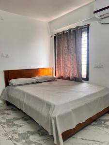 a bedroom with a large bed with a window at S ROOMs in Pithāpuram