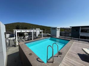 a swimming pool on the roof of a house at The Den Apartements Stellenbosch in Stellenbosch