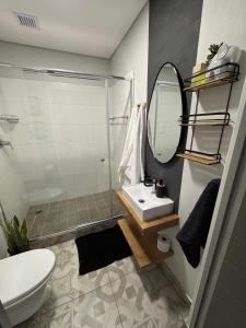 a bathroom with a sink and a mirror at The Den Apartements Stellenbosch in Stellenbosch