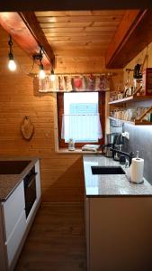 a kitchen with a sink and a counter top at Chata Sauna Sosna in Litmanová