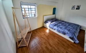 a bedroom with a bed and a ladder in it at PHUONG LAN Homestay in Quy Nhon