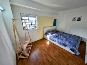 a bedroom with a bed and a ladder in it at PHUONG LAN Homestay in Quy Nhon