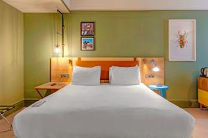 a large white bed in a room with green walls at Bristol Grand by Sunday in Bristol +94 photos