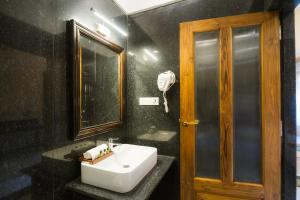 a bathroom with a sink and a mirror at The Rising Haveli in Jaisalmer +26 photos