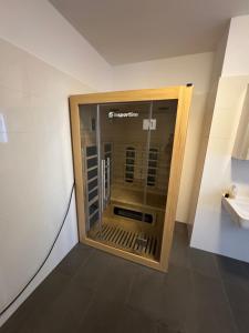 a glass door in a room with a sink at Lux 11 in Sonnenalpe Nassfeld +13 photos