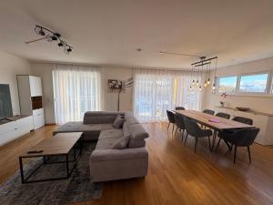 a large living room with a couch and a table at Lux 11 in Sonnenalpe Nassfeld