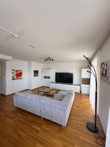 a large living room with a large couch at Lux 11 in Sonnenalpe Nassfeld