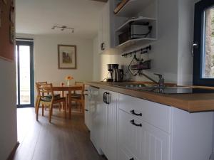 a kitchen with a sink and a table at Herberge Landstreicher in Königstein an der Elbe
