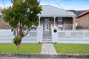 a white fence in front of a house at sage cottage, lithgow - close to everything in Lithgow