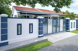 a white and blue fence in front of a house at Aahana Homestay in Merlimau