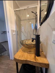 a bathroom with a stone sink on a wooden table at Cascina 1956 in Palestrina +47 photos
