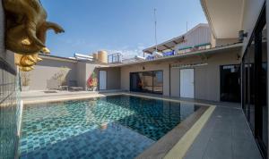 a swimming pool in the backyard of a house at Gu Hotel Patong in Patong Beach