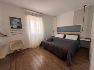 a bedroom with a bed and a chair in it at Cascina 1956 in Palestrina