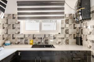 a kitchen with a sink and a microwave at Baidehi Cottage in Rishīkesh +52 photos