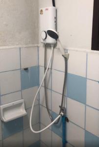 a blow dryer on the wall of a bathroom at MeeboonHome in San Kamphaeng +36 photos