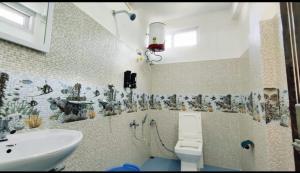 a bathroom with a sink and a toilet at Khowti Stay in Dirang Dzong