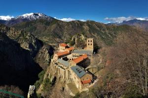 a monastery on the side of a mountain at La Pommeraie in Casteil