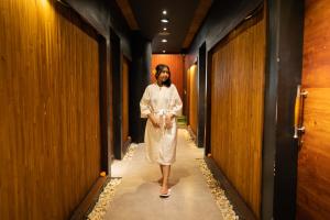 a man with a beard walking down a hallway at Villa Jerami & Spa in Seminyak