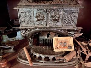 an old stove with a box on top of it at Barossa Valley’s Captain Rodda’s Cottage in Angaston +22 photos