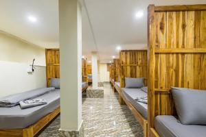 a row of wooden bunk beds in a room at Nongkhiaw IngIng Backpackers Hostel in Nongkhiaw