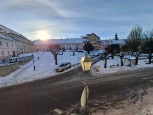 a street light on the side of a road with snow at Apartament Lewin Kłodzki in Lewin Kłodzki