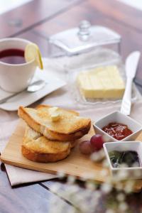 a plate of toast and grapes and a cup of coffee at König Hotel in Pécs +24 photos