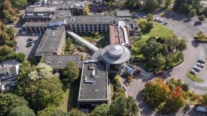 an aerial view of a building with a train in a park at Daresbury Park Hotel in Daresbury