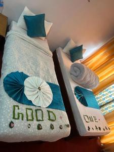two beds with umbrellas on them in a room at Hotel Good one in Pokhara