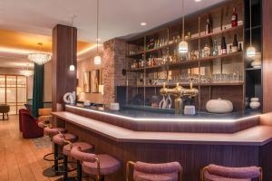a bar in a restaurant with stools at Hôtel Brittany in Paris