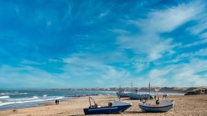 a group of boats sitting on the beach at Villavilla 637 - Vorupør, Nordjylland in Stenbjerg