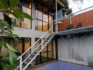 a staircase on the side of a building with windows at Selaras Heritage Villa in Campaka